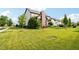 Expansive, grassy backyard with mature trees surrounding the property at 1521 Avondale Dr, Westfield, IN 46074
