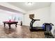 A basement area features a pool table and workout equipment for recreation and fitness at 1521 Avondale Dr, Westfield, IN 46074