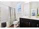 This bathroom features a tub with shower curtain, a toilet, and a vanity with a sink at 1521 Avondale Dr, Westfield, IN 46074