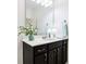 Bathroom vanity with dark cabinetry, a white countertop, and a large framed mirror at 1521 Avondale Dr, Westfield, IN 46074