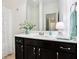 Bathroom features vanity with dark cabinets, light counter tops, and a large mirror at 1521 Avondale Dr, Westfield, IN 46074