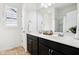 Bathroom featuring double sinks, dark cabinets, white countertops, and natural light at 1521 Avondale Dr, Westfield, IN 46074