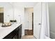 Bright bathroom showcasing double sinks, dark cabinetry, and a shower with curtain at 1521 Avondale Dr, Westfield, IN 46074