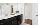 Bathroom with double sink vanity, dark cabinets, white countertops, and a large mirror at 1521 Avondale Dr, Westfield, IN 46074