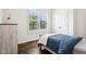 Bright bedroom features wood floors, a large window with shutters, and a cozy blue comforter set at 1521 Avondale Dr, Westfield, IN 46074