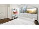 Bright bedroom features a window with plantation shutters, a desk, dresser, and a television at 1521 Avondale Dr, Westfield, IN 46074