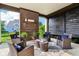 Covered outdoor patio, featuring a stylish brick fireplace and comfortable seating for relaxing or entertaining at 1521 Avondale Dr, Westfield, IN 46074
