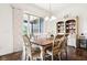 Bright dining room with wood table and six chairs, hutch, and sliding glass doors to patio at 1521 Avondale Dr, Westfield, IN 46074