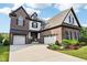 Beautiful two-story brick home featuring a three-car garage and manicured landscaping at 1521 Avondale Dr, Westfield, IN 46074