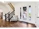 Bright foyer with hardwood floors, staircase, and decorative chair to enjoy the natural light at 1521 Avondale Dr, Westfield, IN 46074