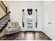 Inviting foyer with a chair by the window, a staircase, and views of the home's entrance at 1521 Avondale Dr, Westfield, IN 46074