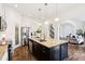 Large kitchen island with granite countertops, stainless steel appliances, and adjacent living room at 1521 Avondale Dr, Westfield, IN 46074