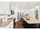 Bright kitchen features granite countertops, stainless steel appliances and dark wood flooring at 1521 Avondale Dr, Westfield, IN 46074