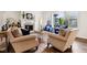 Living room features a fireplace, two large windows, and two comfortable armchairs at 1521 Avondale Dr, Westfield, IN 46074