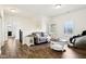 Spacious living room features wood floors, gray couch, and a unique accent table at 1521 Avondale Dr, Westfield, IN 46074