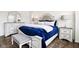 Bright main bedroom features a king sized bed, matching nightstands, and light wood floors at 1521 Avondale Dr, Westfield, IN 46074