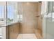 Close-up of the tile and glass shower showcasing a built-in bench and shampoo niche at 1521 Avondale Dr, Westfield, IN 46074