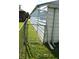 Side yard area featuring a grass lawn, metal fence, and view of the home's exterior at 1641 Winton Ave, Speedway, IN 46224