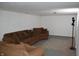 Basement recreational space includes a seating area with couches and a neutral patterned rug at 1641 Winton Ave, Speedway, IN 46224