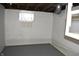 Unfinished basement has painted walls and floor, and a window at 1641 Winton Ave, Speedway, IN 46224