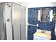 Bathroom with blue tiled wall, glass shower, and modern vanity, ideal for everyday use at 1641 Winton Ave, Speedway, IN 46224