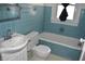Retro bathroom with blue tiling, a window, and a combined tub and shower at 1641 Winton Ave, Speedway, IN 46224
