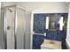 A full bathroom features a shower and blue tiling at 1641 Winton Ave, Speedway, IN 46224