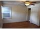 Bedroom features hardwood floors, a ceiling fan, a window with blinds, and a closet at 1641 Winton Ave, Speedway, IN 46224