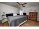 Cozy bedroom with hardwood floors, a comfortable bed, vintage furnishings, and soft, natural light at 1641 Winton Ave, Speedway, IN 46224