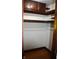 Interior closet view with wooden shelves and rack, offering ample storage space at 1641 Winton Ave, Speedway, IN 46224