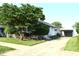 Charming home with a well-manicured lawn, mature trees, and an inviting driveway at 1641 Winton Ave, Speedway, IN 46224