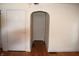 Hallway features hardwood floors, neutral paint, and two doorways at 1641 Winton Ave, Speedway, IN 46224