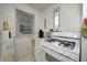 Kitchenette includes a white gas range, white countertop and a large window at 1641 Winton Ave, Speedway, IN 46224