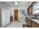 Kitchen features white appliances, wooden cabinets, and linoleum flooring at 1641 Winton Ave, Speedway, IN 46224