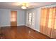 The bright living room features hardwood floors, double doors, and neutral paint at 1641 Winton Ave, Speedway, IN 46224