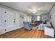 Inviting living room featuring a plaid sofa, ceiling fan, hardwood floors, and ample natural light at 1641 Winton Ave, Speedway, IN 46224