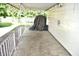 A covered patio with white siding on the home provides additional outdoor living space at 1641 Winton Ave, Speedway, IN 46224