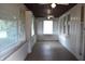 Sunroom with lots of windows, a ceiling fan, and painted brick walls at 1641 Winton Ave, Speedway, IN 46224