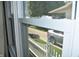 Window view of neighborhood with white picket fence and parked car at 1641 Winton Ave, Speedway, IN 46224