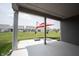 Open-air back porch provides a relaxing space with an umbrella and a view of the spacious backyard at 19800 Sutton Ter, Westfield, IN 46074