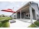 Covered back patio perfect for entertaining or relaxing outdoors with an umbrella and view of the yard at 19800 Sutton Ter, Westfield, IN 46074