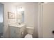 Bright, white bathroom featuring a single vanity, toilet, and decorative wall art at 19800 Sutton Ter, Westfield, IN 46074
