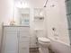 Well-lit bathroom with white cabinets, toilet, and combined tub and shower at 19800 Sutton Ter, Westfield, IN 46074
