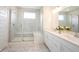 Modern bathroom with a tiled shower, glass door, and double sink vanity with granite countertop at 19800 Sutton Ter, Westfield, IN 46074