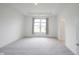 Spacious bedroom with large window, tray ceiling, and neutral carpet at 19800 Sutton Ter, Westfield, IN 46074