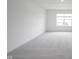 Large, carpeted bonus room with natural light streaming through the windows at 19800 Sutton Ter, Westfield, IN 46074