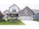 Beautiful two-story home with a white garage door, lush lawn and a welcoming front porch at 19800 Sutton Ter, Westfield, IN 46074