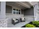 Cozy front porch area with comfortable seating, decorative pillows, and attractive brick accents at 19800 Sutton Ter, Westfield, IN 46074