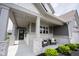 Inviting front porch with comfortable seating, decorative pillows, and classic white pillars at 19800 Sutton Ter, Westfield, IN 46074
