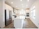 This open kitchen features all white cabinets, stainless appliances and hardwood floors at 19800 Sutton Ter, Westfield, IN 46074